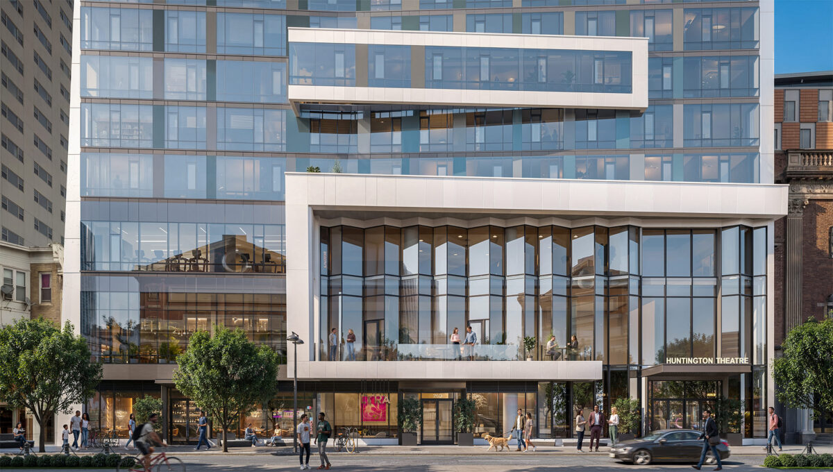 Contemporary glass building entrance with ground-floor retail and pedestrians