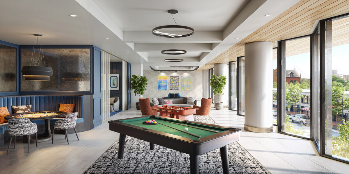Modern game lounge with pool table, seating area, and large windows with city views