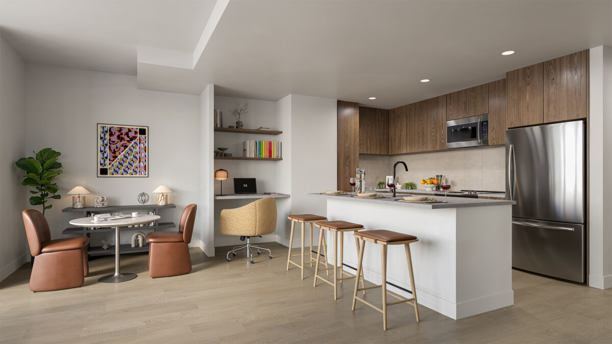 Open kitchen and dining area with bar seating and workspace nook